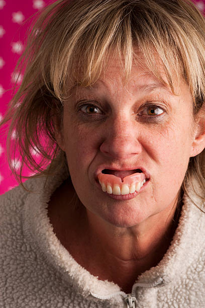 Senior Woman Spitting Out Teeth Stock Photo - Download Image Now - Dentures,  Humor, Women - iStock
