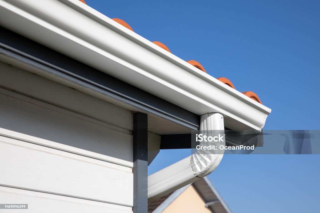 Roof showing gutters aluminum and soffit on the back of wooden house Roof Gutter Stock Photo