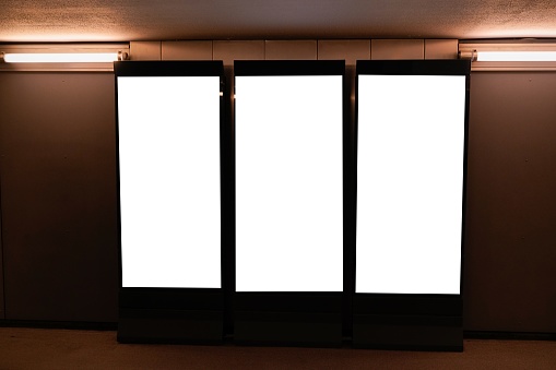 Three blank billboard advertising space on wall for mock up digital advertising placement template