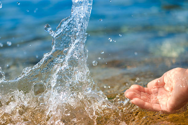 istock Hand splashing clean water on blue sea background. Environmental concept 146909729