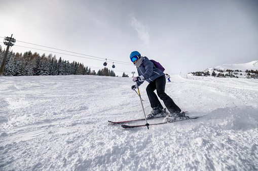 Mature woman skiing on ski slope in European Alps, Austria. 
Sunny winter day.
Canon R5