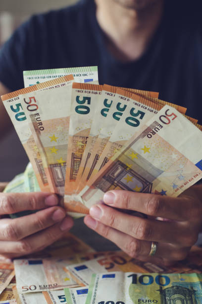 istock Euro banknotes in man's hand, working in office 1469100759