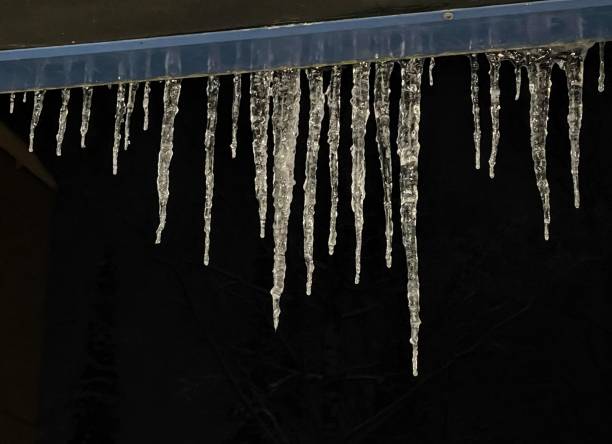 istock Winter nature decoraton, hanging icicles on the dark background 1469100802