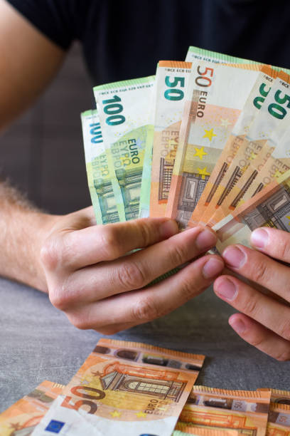 istock Euro banknotes in man's hand, working in office 1469100818