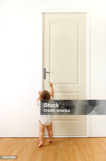 Cute Toddler Reaching For Doors Handle Ready To Go Stock Photo - Download Image Now