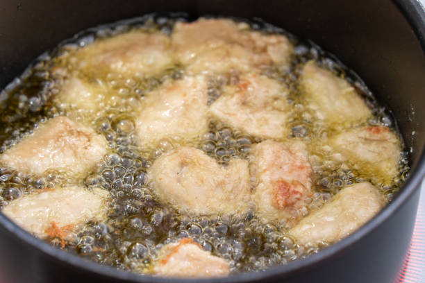 istock housewife making fried chicken in her home IH kitchen 1469104789