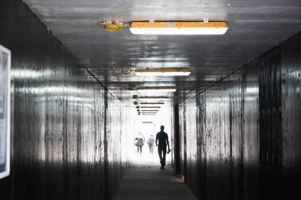 istock Unrecognised man walking in a dim tunnel in London 1469104871