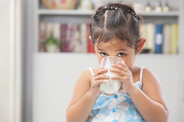 istock Little Asian girl drinking milk 146910824
