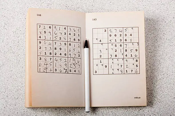 A book of Sudoku puzzles partially completed
