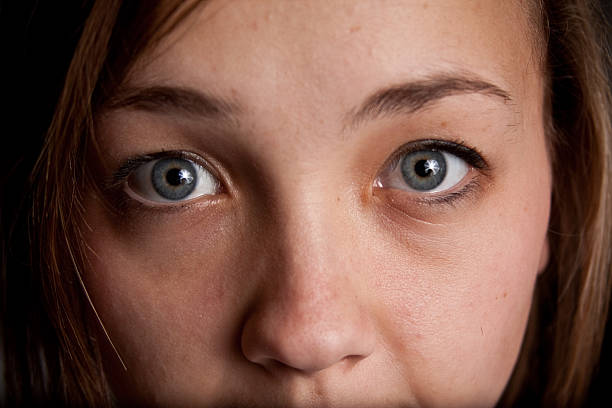 Young Woman's Innocent Gaze Into Camera stock photo