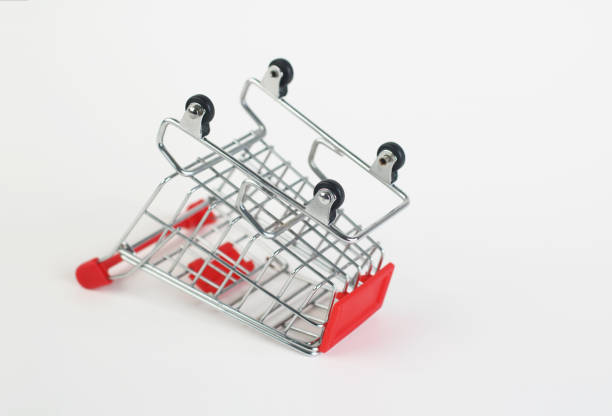Overturned empty grocery shopping cart. Isolated on white background.
