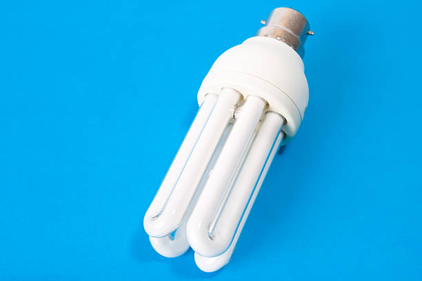 Energy saving bulb on blue background stock photo