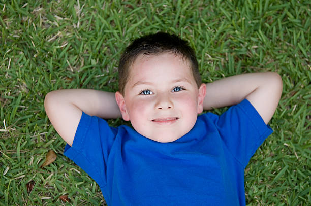 istock Happy child laying on grass 146911647