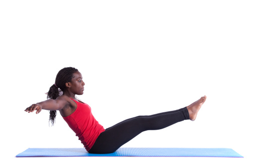 young african woman exercising with perfect body balance (isolated on white)