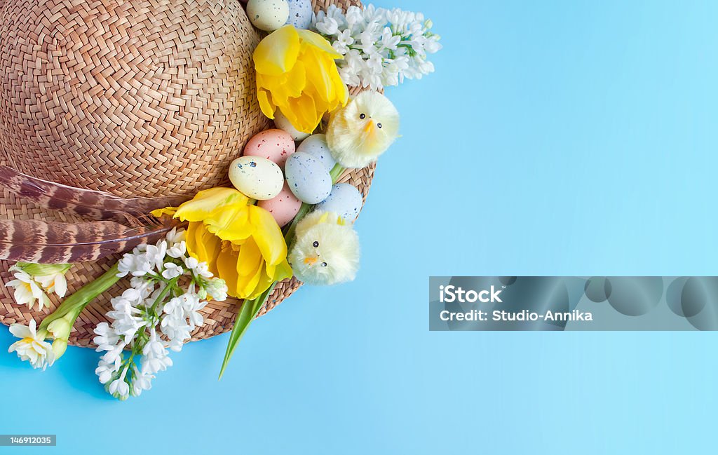 Easter has Straw hat decorated for easter with flowers, chicks and easter eggs Easter Stock Photo