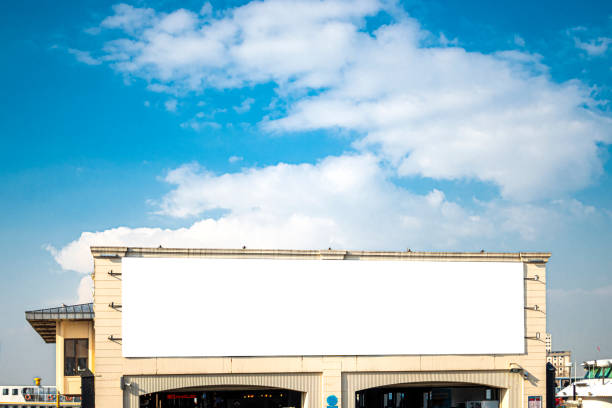 Horizontal blank billboard on the city square in background buildings and road with cars mock up