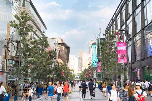 people walk to the new look of siam square in bangkok thailand. siam square is popular among teen and tourists in thailand. - siam square imagens e fotografias de stock