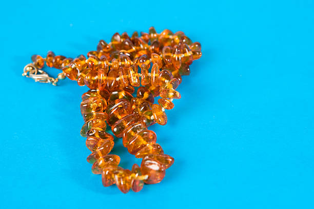 Amber necklace on blue background stock photo