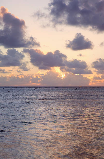 istock Sun sinks to Sea under a cloud-filled Sky at Sunset 146912890