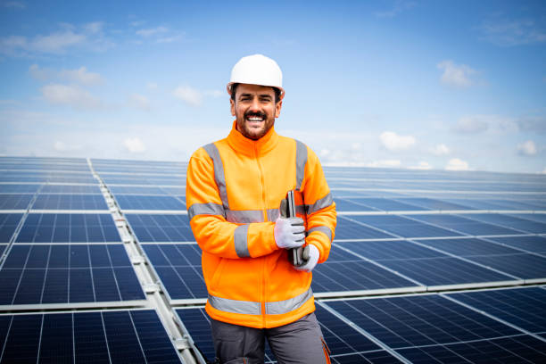 istock Renewable energy technologies concept and engineer standing in large solar power plant. 1469129336