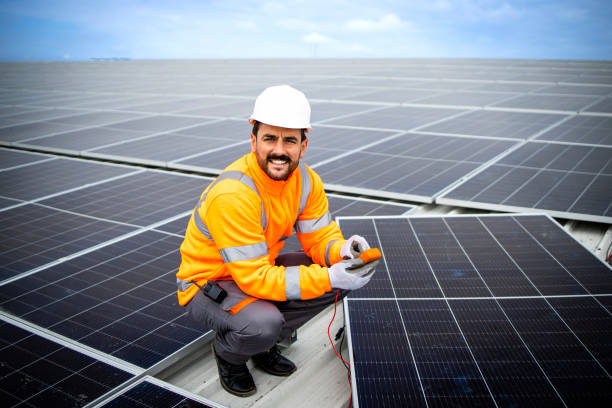 istock Solar energy industry worker standing on the rooftop holding electrical measuring device and checking panel installation. 1469129498