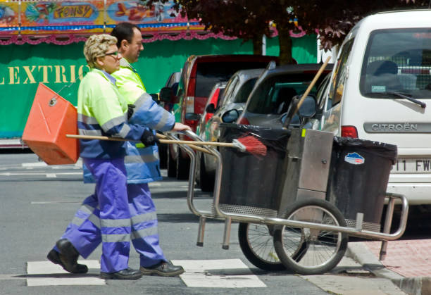 Street sweepers pushing cart and equipment. stock photo