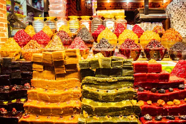 Photo of Piles of various colorful tasty candy sweets on bazaar for sale in iranian street market