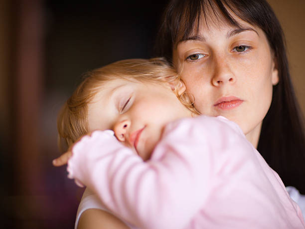 istock Child sleeping on mother's shoulder 146913563