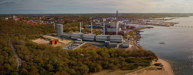 View of coastal power station with steam accumulator. The modular gas engine cogeneration plant in Kiel. Combined heat and power station for heat engine and power station to generate electricity.