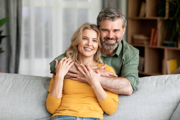 istock Portrait Of Smiling Middle Aged Spouses Posing In Home Interior 1469136576