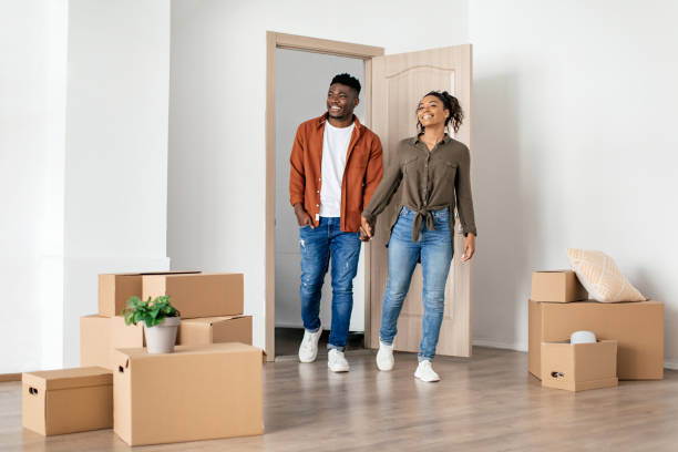 istock Happy Black Spouses Holding Hands Entering New Home 1469136813