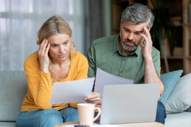 istock Financial Crisis. Pensive Middle Aged Couple Checking Documents At Home 1469136835