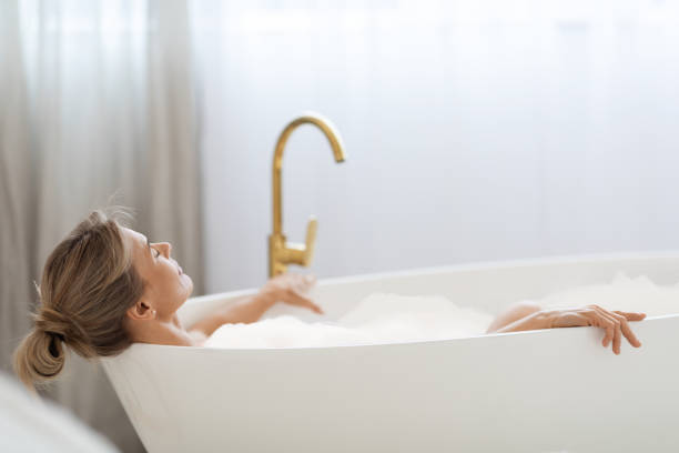 istock Relaxed lady enjoying foamy aromatic bath at home 1469136872