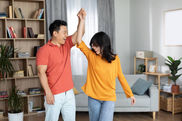 istock Happy korean spouses having fun at home, dancing 1469136891