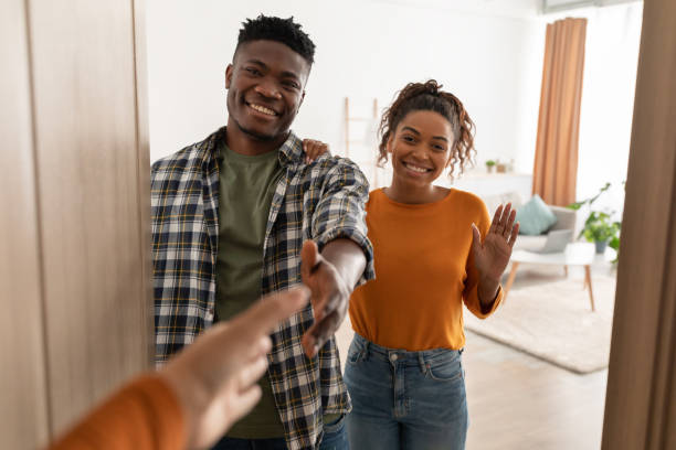 istock Cheerful Black Spouses Stretching Hands For Handshake Standing Indoors 1469137050