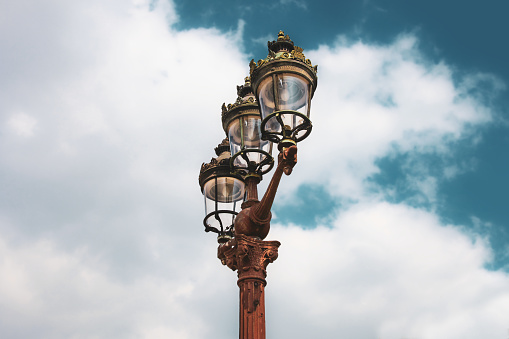 A typical historic public streetlight located at Place de la Concorde in the 8th Arrondissement (Arrondissement de l’Élysée) of Paris, France.