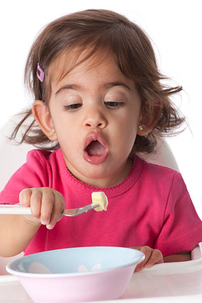 istock Baby girl is taking a large bite 146913818