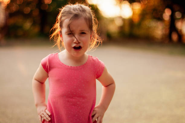 istock Little girl standing in public park and crying while looking at camera 1469140596
