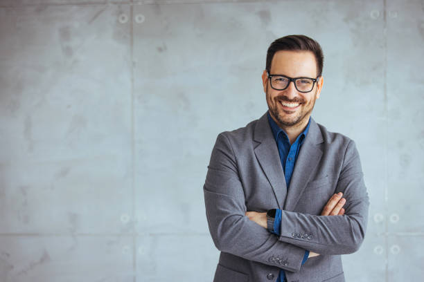 istock Businessman smiling with arms crossed on white background. 1469142854