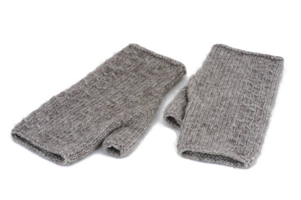 istock Gray knitted mittens isolated on a white background. 1469147267