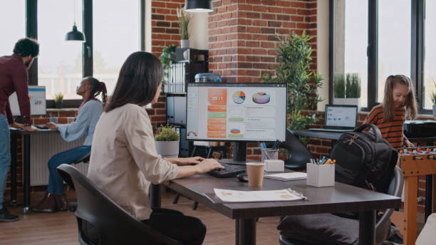 istock Single mom multitasking while her little girl is playing foosball in the office at work 1469147863