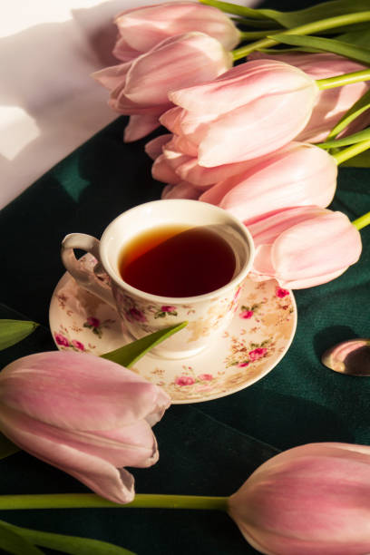 istock A cup of tea with pink tulips on table 1469148119
