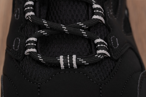 Close up of laces on a black shoe