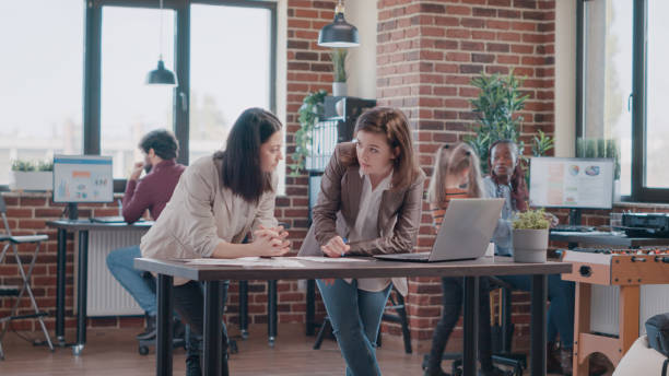istock Single mom trying to work with colleague while daughter disturbing work 1469150167