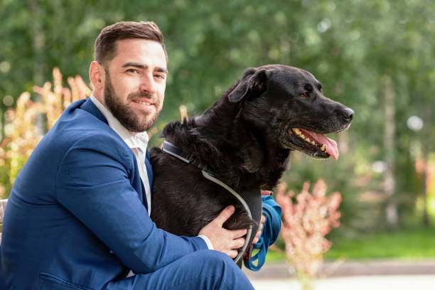 istock Man with his dog in park 1469150276