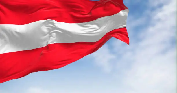 The national flag of Austria waving on a clear day. Three equal horizontal bands: white, red upper & lower, middle band. 3d illustration render. Rippled fabric.