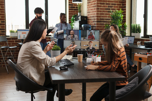 Financial company colleagues brainstorming client oriented project ideas while in digital meeting. Business woman on virtual conference videocall communicating marketing strategy to partners.