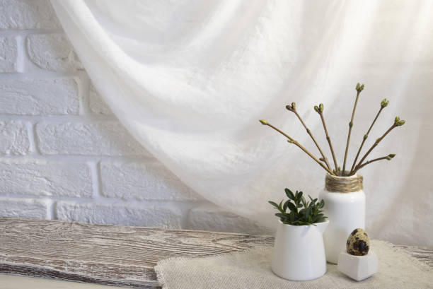 istock Branches in buds and leaves in a vase in the interyer 1469152070