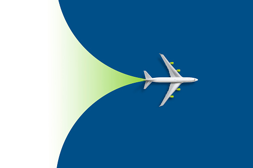 White modern passenger plane against blue and green background