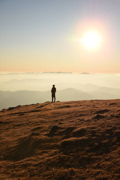 istock A man standing on the hill and watching the sunset 1469154260